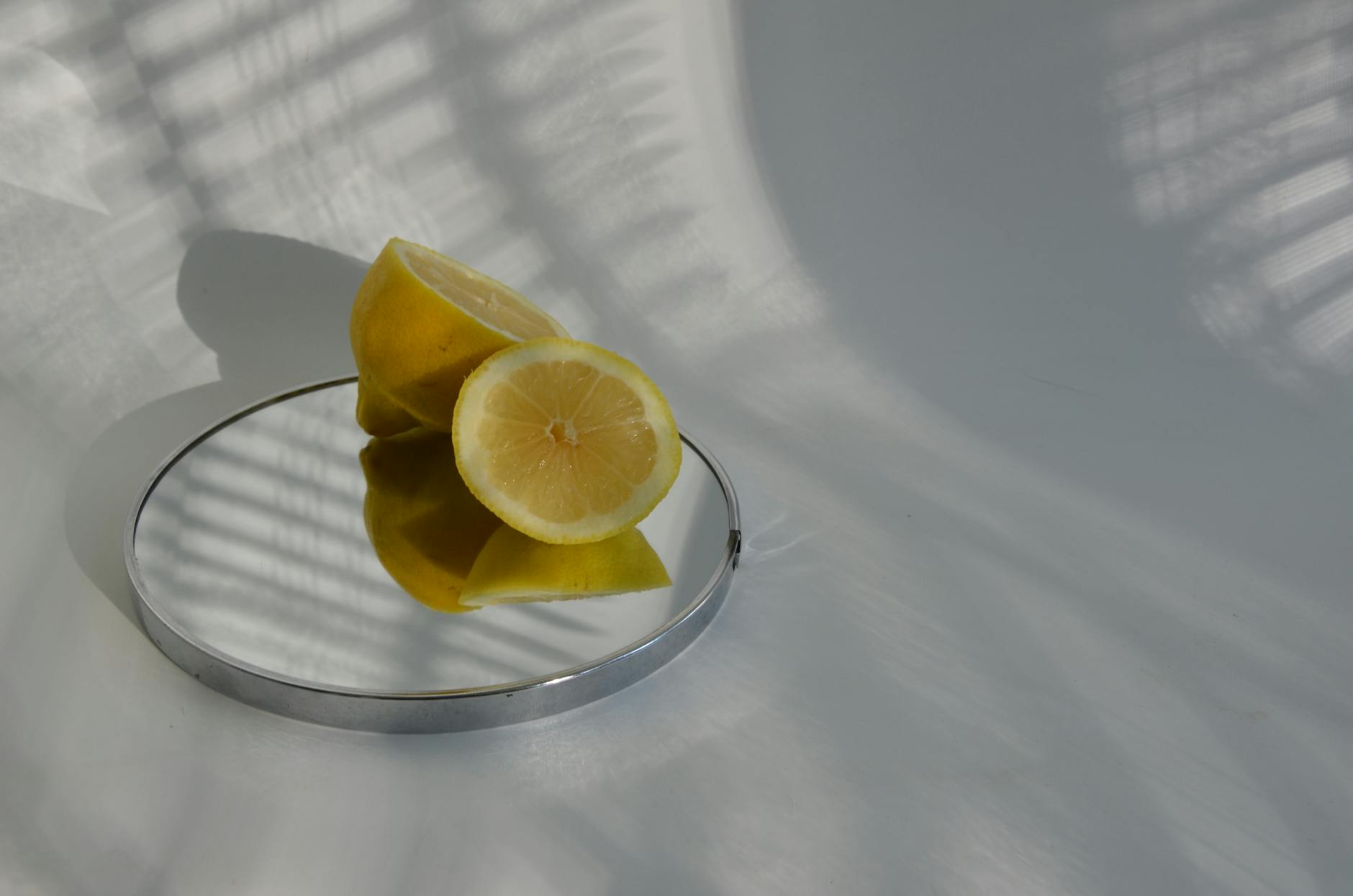 Hand holding a lemon on soft pink background, representing shifting sensation during perimenopause