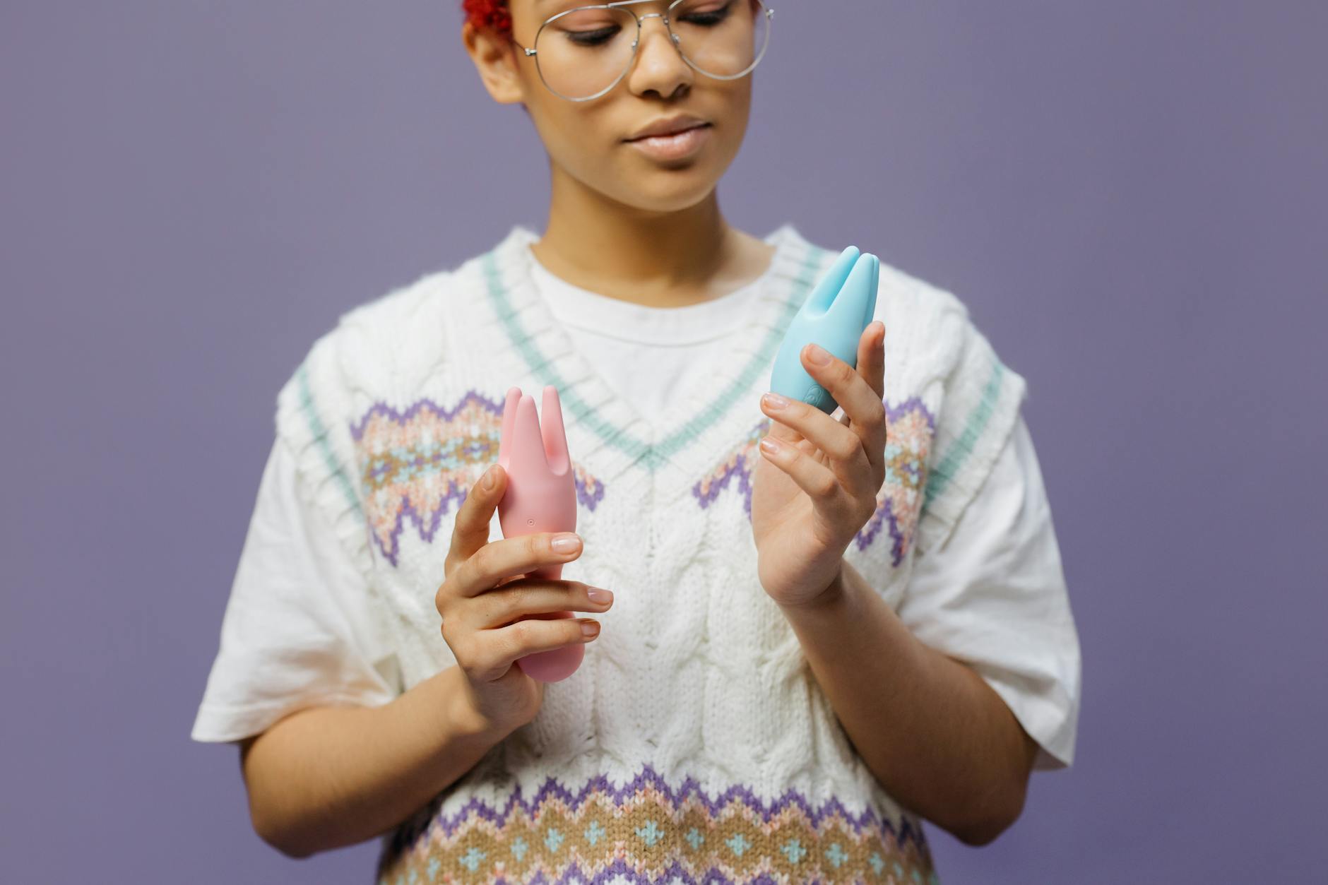 Two people in different locations holding vibrators while connected through video call.
